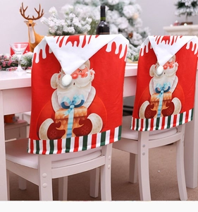 Detail of red Christmas chair back covers with Santa Claus print and white pom-pom ball