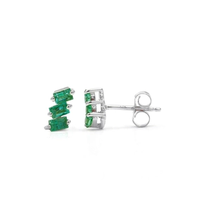 Macro detail of S925 sterling silver earrings with three green step-cut zircon stones