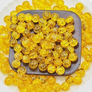 Macro shot of 10mm golden frosted glass beads with internal crackle patterns for DIY jewelry