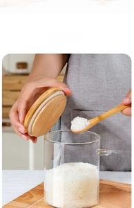 Detail of high borosilicate glass storage jar with airtight wooden lid and spoon