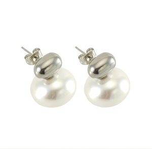 Detailed view of French vintage pearl stud earrings with polished silver metal finish