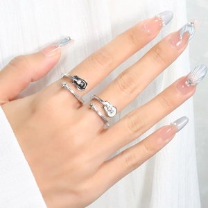 Macro shot of silver guitar rings with crystal accents on a model's hand