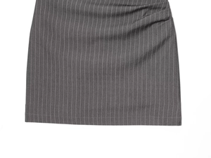 Detailed macro view of the grey pinstripe woven fabric hem and pleated dress stitching