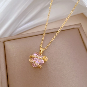 Pink heart pendant necklace with shimmering crystals on a gold-plated titanium chain