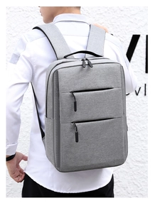 Close-up of padded shoulder straps and wear-resistant fabric on the grey laptop backpack