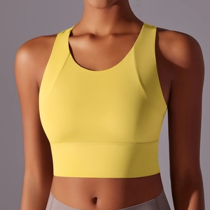 Front view of bright yellow sports bra featuring round neck and wide elastic hem