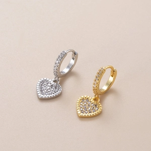 Close-up of heart charm hoop earrings with micro-pave cubic zirconia in gold and silver