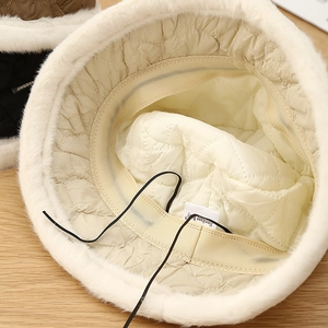 Close-up of winter bucket hat with faux fur trim, quilted lining and adjustable drawstring