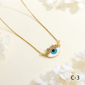 Detailed close-up of Evil Eye necklace pendant with colorful zircon and gold chain