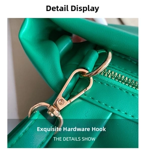 Detailed macro view of the premium golden metal lobster clasp and green leather stitching