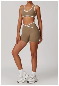 Detail of high-waist yoga set with contrast trim and cross-waist athletic shorts