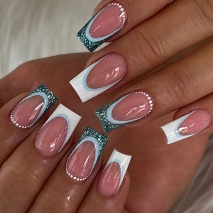 Detail of blue French ballet press-on nails with white dots and glitter tips design