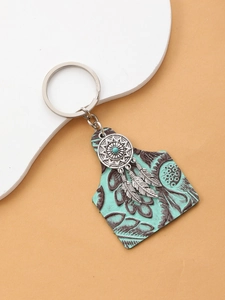 Close-up of vintage dreamcatcher keychain with embossed leather and turquoise beads