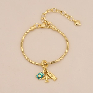 Macro detail of gold travel bracelet featuring passport, plane and boarding pass charms