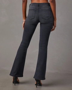 Back view of dark grey flare jeans showing a flattering fit and rear pocket details