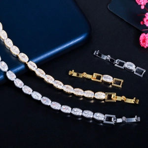 Detailed view of marquise-cut zircon tennis bracelets in gold and silver with extension clasps