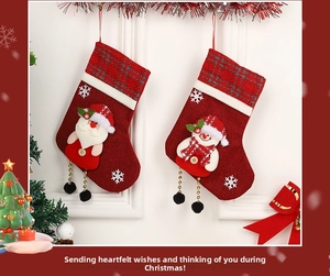 Detail of 2-pack Santa and Snowman Christmas stockings with plaid cuffs and embroidery