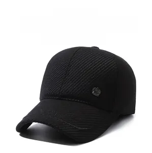 Detailed close-up of a black winter baseball cap showing thick twill fabric and metal star icon
