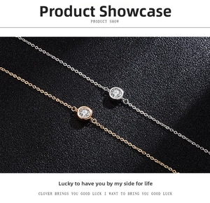 Detail of minimalist bubble bracelets in gold and silver with round cut moissanite stones