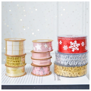 Close-up of assorted festive ribbons with glitter snowflakes and stars on a white book