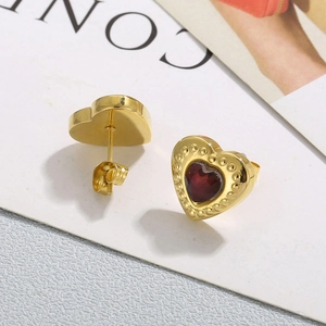 Detailed view of red heart stud earrings with golden beaded edges and butterfly backs