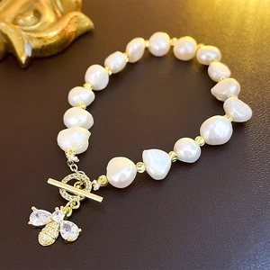 Elegant Baroque pearl bracelet with golden bee charm and sparkling zircon stones