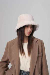 Close-up detail of soft plush faux fur texture on a light pink fisherman bucket hat