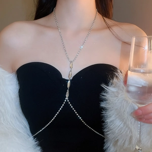 Macro view of silver layered body chain with marquise rhinestones on black dress