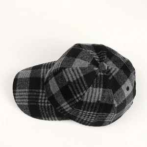 Detailed view of the thick wool plaid pattern and six-panel structure of the baseball cap