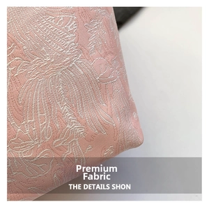 Macro detail of pink silk brocade fabric with intricate silver floral embroidery patterns