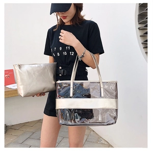 Detail view of transparent PVC tote with champagne gold inner pouch on a model