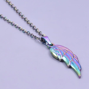 Rainbow wing pendant necklace in polished stainless steel on purple backdrop