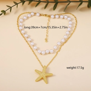 Detail of double-layer necklace with white pearls and golden starfish pendant