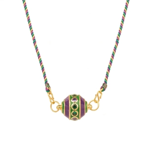 Close-up of gold-plated tarot pendant with purple and green enamel and braided rope cord