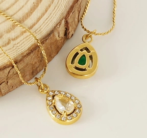 Macro shot of 18K gold plated water drop necklace with green zircon and fine chain