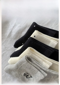 Detail of rib-knit cotton socks with cute cartoon puppy embroidery in grey and white