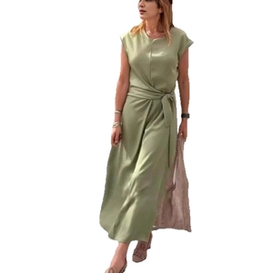 Detail view of sage green sleeveless maxi dress featuring a cinched waist with tie belt