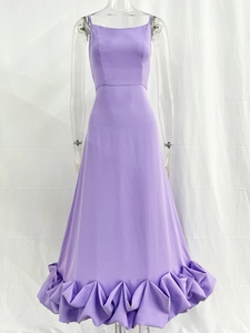 Detail of lavender purple evening gown featuring tiered cascading ruffle skirt and slim fit