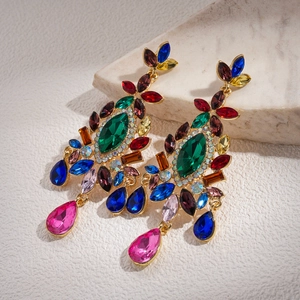 Detailed macro view of vintage floral drop earrings with colorful crystals and gold plating