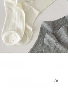 Detail showing high-quality bamboo fiber texture in cream and grey slouchy mid-calf socks