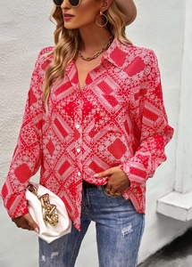 Detail of red long sleeve shirt with white paisley floral print and button-up collar