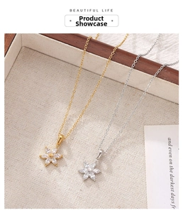 Detailed macro view of gold and silver flower pendants featuring cubic zirconia petals