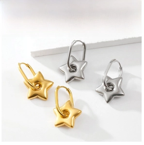 Detail showing gold and silver star pendant earrings in a minimalist U-shaped design