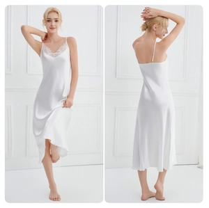 Detailed view of white satin sleepwear with lace V-neckline and elegant fishtail hem