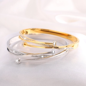 Luxury crisscross nail bangle in gold and silver finish with pavé set crystals