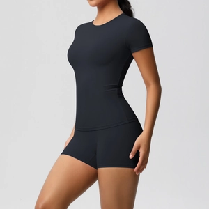 Rear view of women's black high-stretch sports set featuring tight t-shirt and yoga shorts