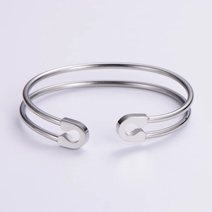 Detailed view of silver minimalist 304 stainless steel open bangle with safety pin design