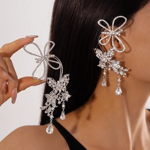 Detail of silver butterfly ear cuff with sparkling rhinestones and long tassel fringe