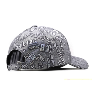 Detail of adjustable metal buckle and full alphabet print on grey baseball cap