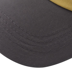 Macro detail of dark grey cotton baseball cap brim with precise parallel stitching lines